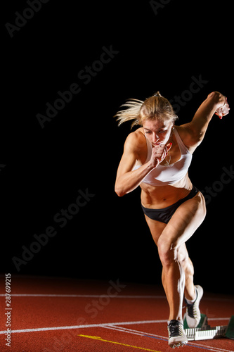 Female fit runner athlete starting running race