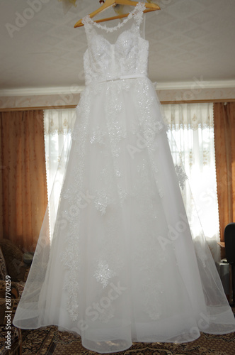 Bride's dress. White dress. Grooming dress White dress in the center of the room.