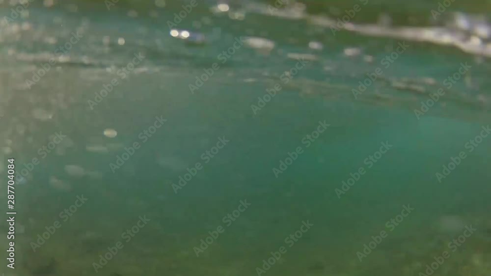 POV of swimmer ducking under an ocean wave, with viewpoint of above water and underwater. POV of swimmer ducking under an ocean wave, with viewpoint of above water and underwater.