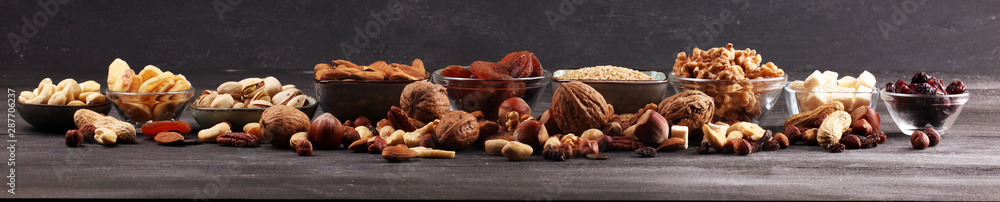 Composition with dried fruits and assorted healthy nuts on rustic background Composition with dried fruits and assorted healthy nuts on rustic background