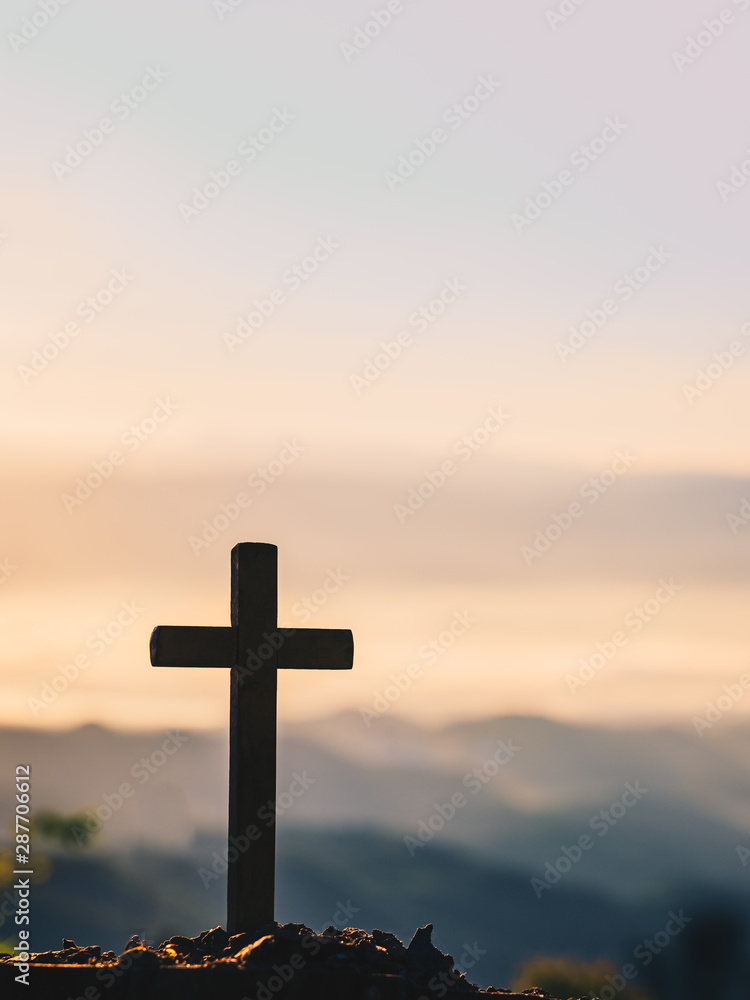 Cross on the blurred mountain natural background.