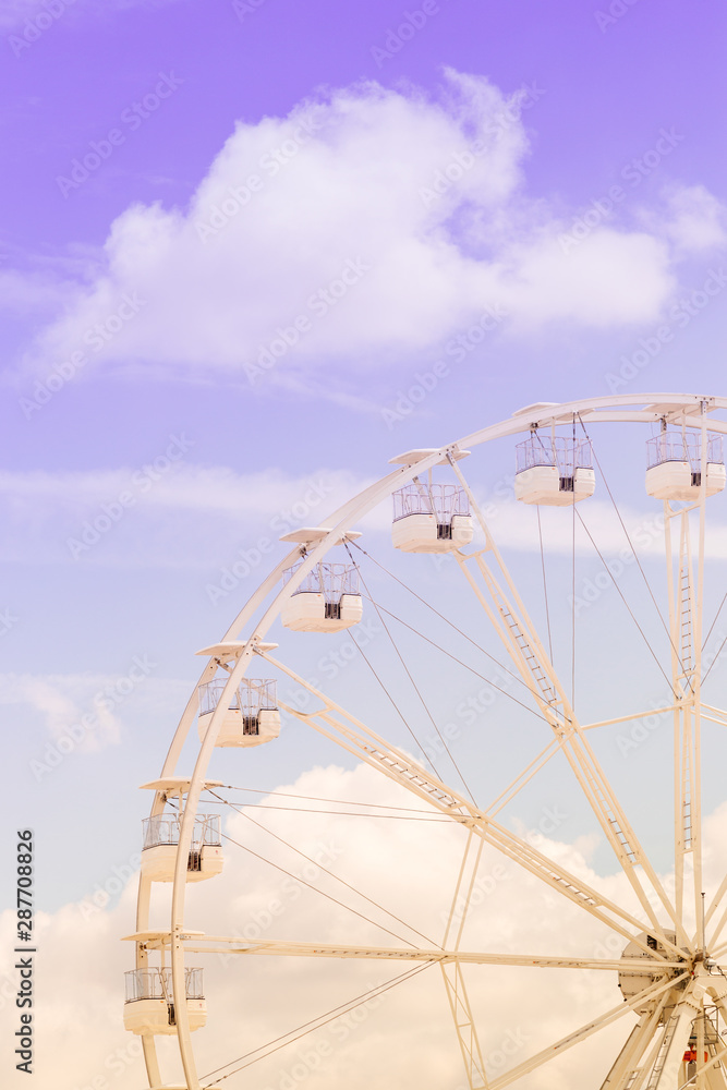 Ferris wheel on the colorful cloudy sky. Background concept of happy holidays time. Ferris wheel on the colorful cloudy sky. Background concept of happy holidays time.