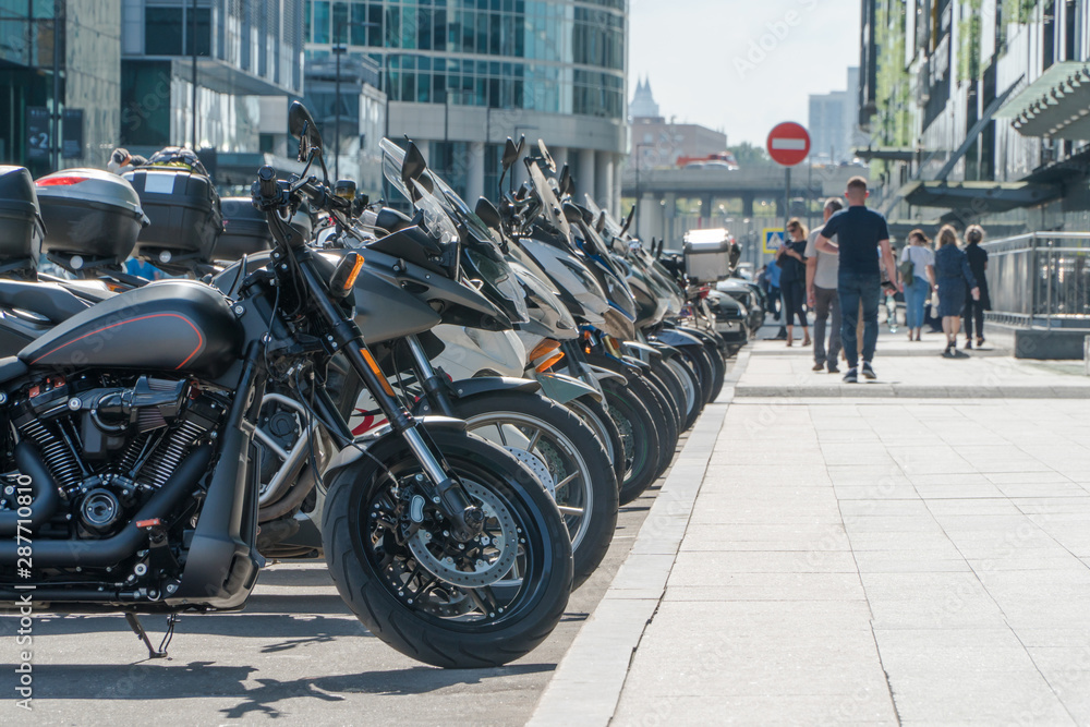 row of parked motorbikes in city scene
