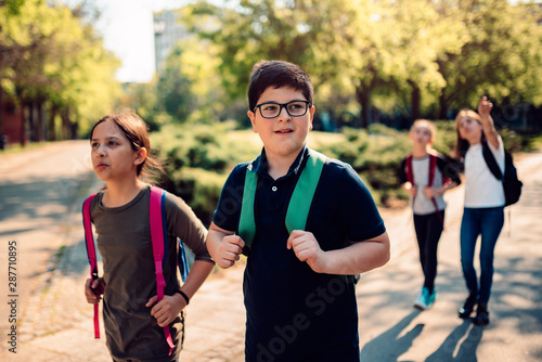 Classmates at schoolyard going to school