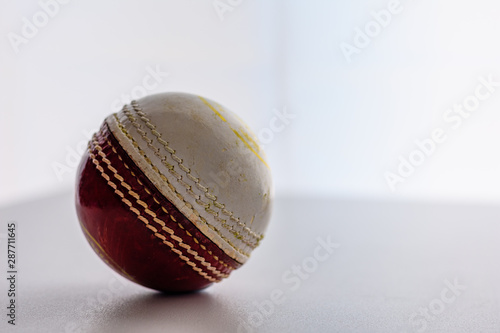 A hard leather cricket ball, isolated.