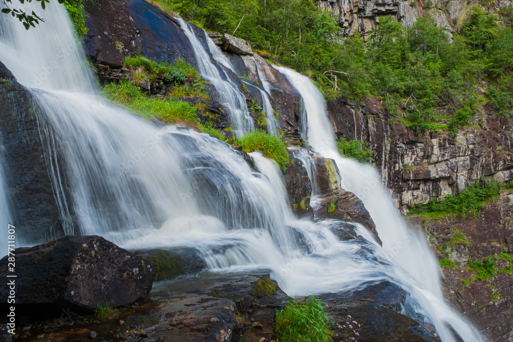 Element of waterfall Skjervsfossen in summer, seen from the top viewpoint. Shot with long exposure. Norway. July 2019
