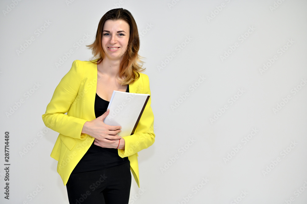 Portrait of a pretty young brown-haired business woman on a white background in a yellow jacket. He stands in different poses, talking, different emotions. Portrait of a pretty young brown-haired business woman on a white background in a yellow jacket. He stands in different poses, talking, different emotions.