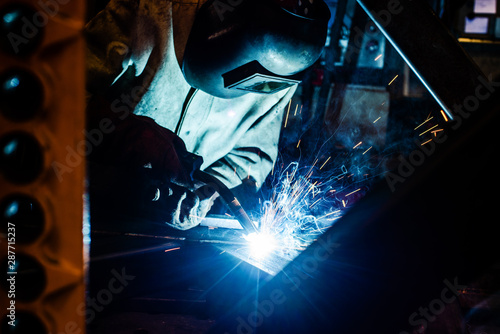 Welder working in factory © Kzenon