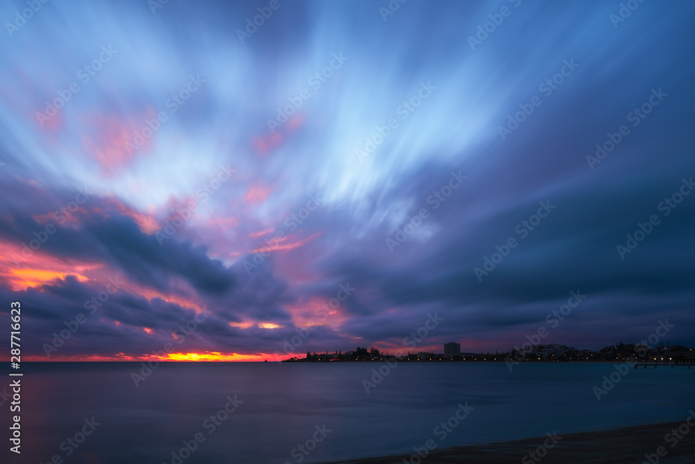 Amazing Sunset at Anse Vata Bay in Noumea, New Caledonia in French Polynesia, South Pacific. Long exposure image.