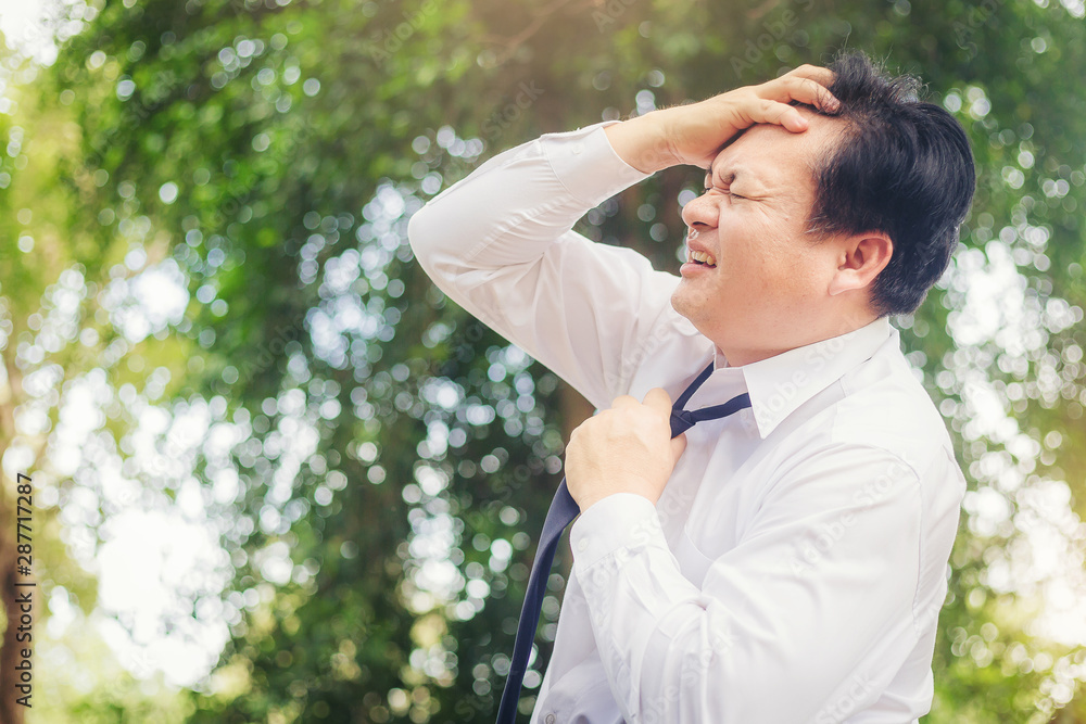 Businessman with painful from a headache from business exhaustion. Businessman with painful from a headache from business exhaustion.