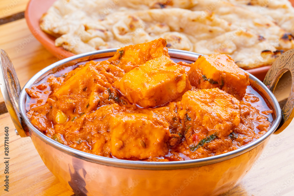Indian Delicious Spicy Vegetarian Cuisine Paneer Toofani Also Know as Paneer Tufani, Toofani Paneer Masala or Dhaba Style Paneer Masala Served with Tandoori Roti on Wooden Yellow Background Indian Delicious Spicy Vegetarian Cuisine Paneer Toofani Also Know as Paneer Tufani, Toofani Paneer Masala or Dhaba Style Paneer Masala Served with Tandoori Roti on Wooden Yellow Background