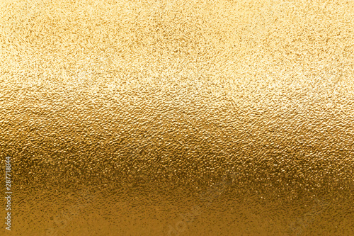 Shiny yellow metallic gold leaf foil texture background
