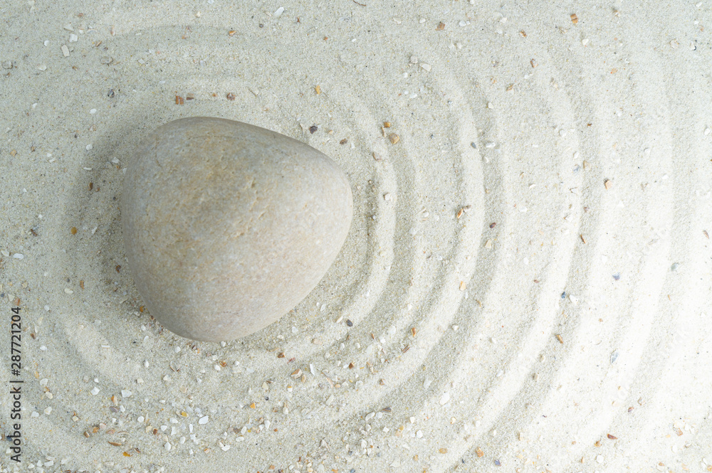 Naklejka premium White stone in white sand, passing through the circles, copy space