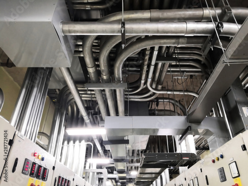 Фотография Full of galvanized steel conduits and Pull box for cable wiring joint with electrical box on cement ceiling at Main Distribution Board room