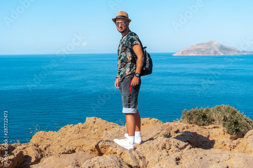 stylish man on the cliff by the sea