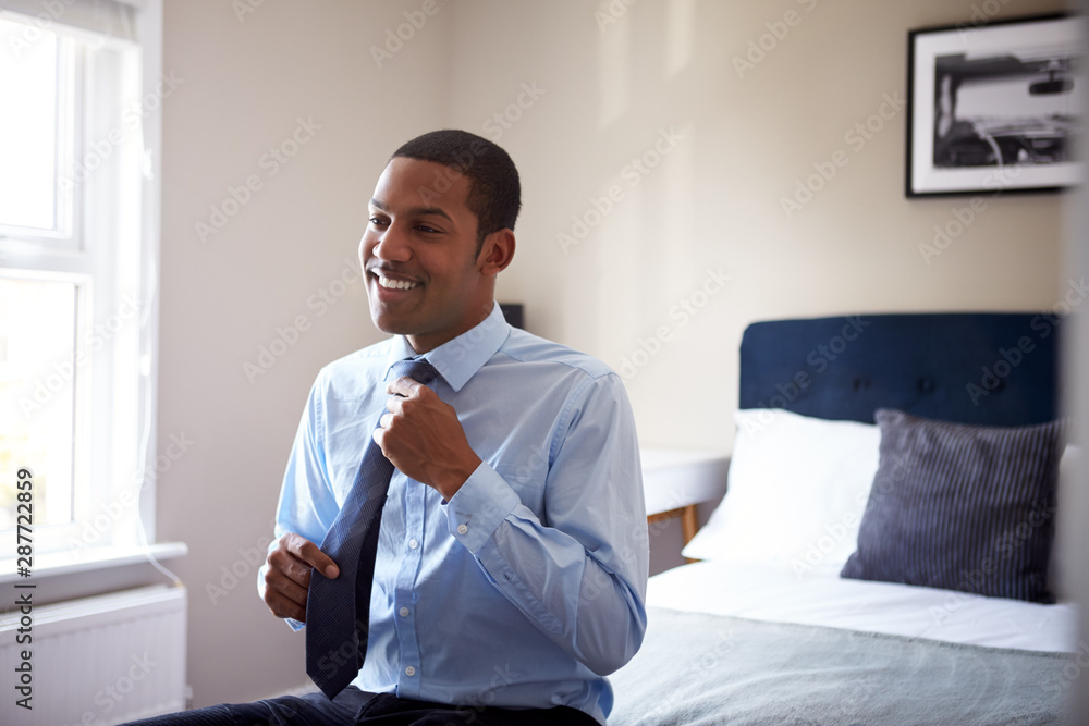 Young Man Getting Dressed In Bedroom For First Day At Work In Office Young Man Getting Dressed In Bedroom For First Day At Work In Office