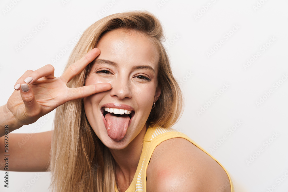 Happy smiling optimistic young pretty woman wearing hat posing isolated over white wall background. Happy smiling optimistic young pretty woman wearing hat posing isolated over white wall background.
