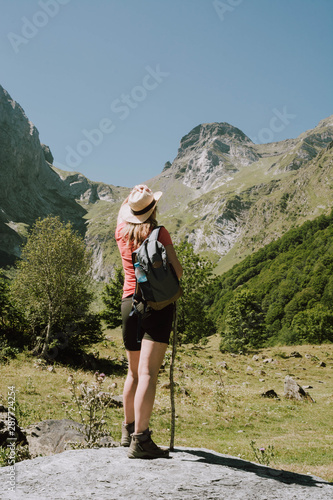 A woman hiking in the Aran valley in Spain, exactly in Artiga de Lin, photo