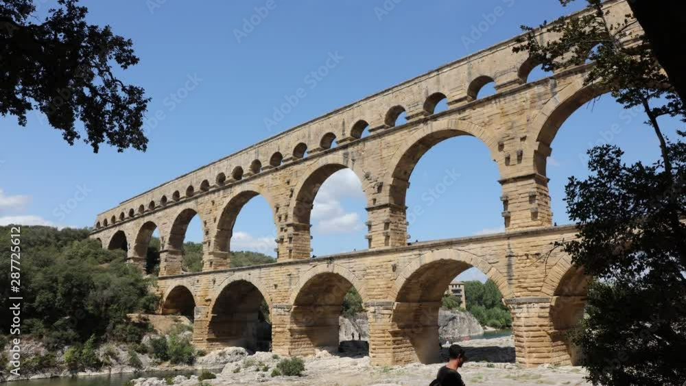 Pont du Gard time lapse - the highest of all preserved ancient roman aqueducts. It crosses the Gardon River near the town of Vers-Pont-du-Gard in southern France Pont du Gard time lapse - the highest of all preserved ancient roman aqueducts. It crosses the Gardon River near the town of Vers-Pont-du-Gard in southern France