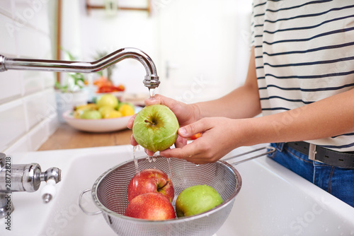 Woman washing seasonal fresh apples photo