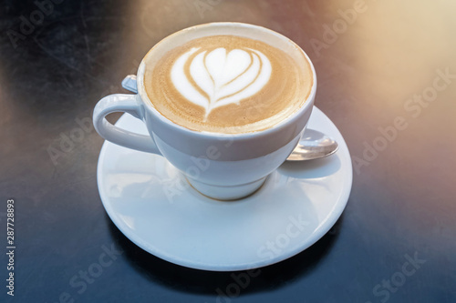 Fresh cappuchino or flat white coffee with latte art close-up