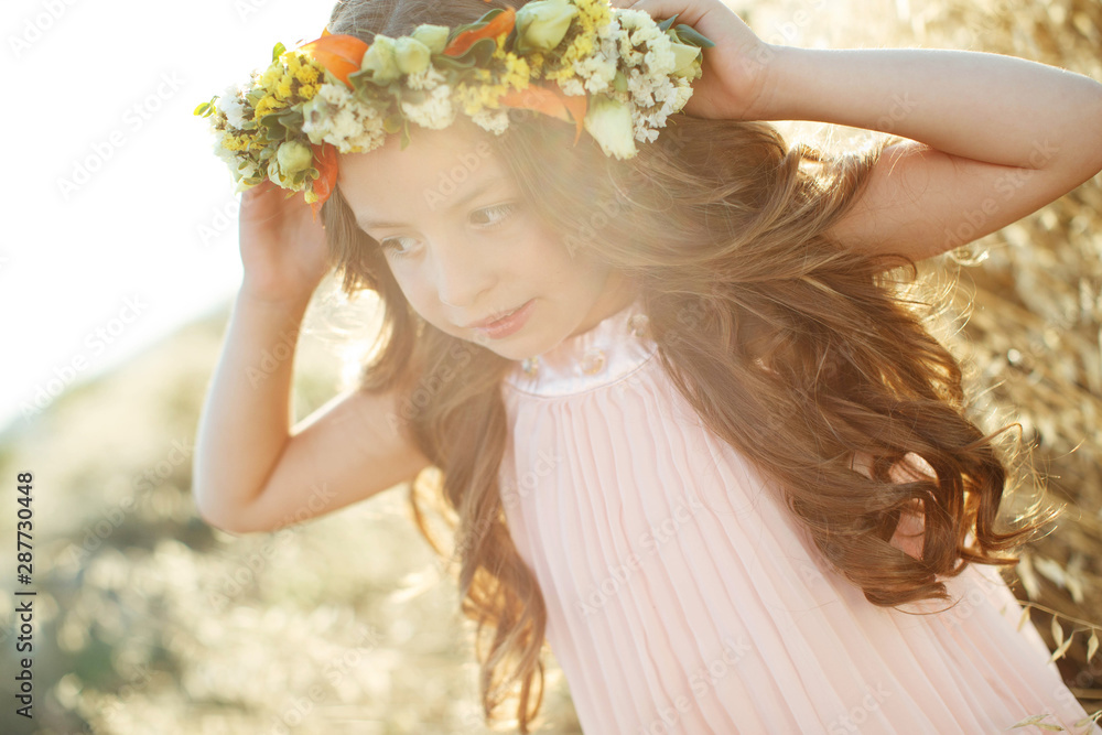Little girl with a wreath and flowers on her head. Little girl with a wreath and flowers on her head.