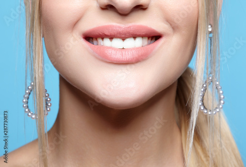 Closeup macro portrait of female red smiling lips with day beauty makeup.