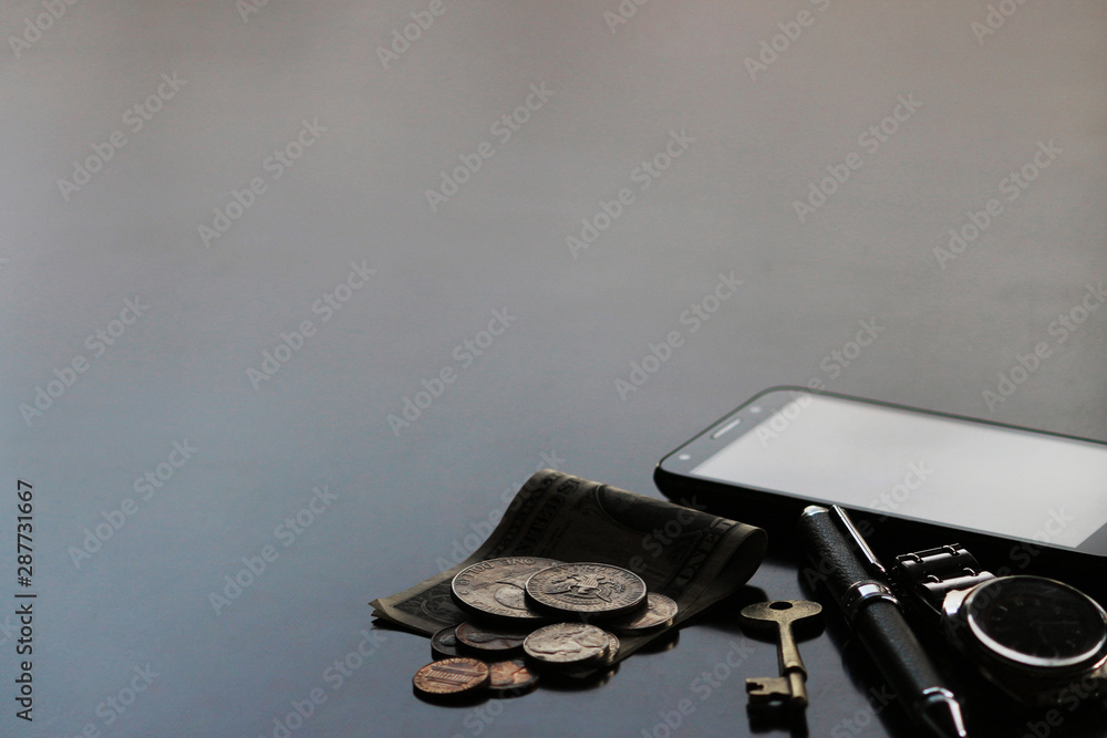 Still life of male cool belongings with dollar bills and coins