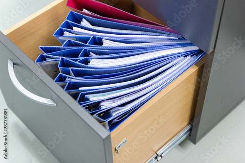 Hand of Man Search files document in a file cabinet in work office, concept business office life.