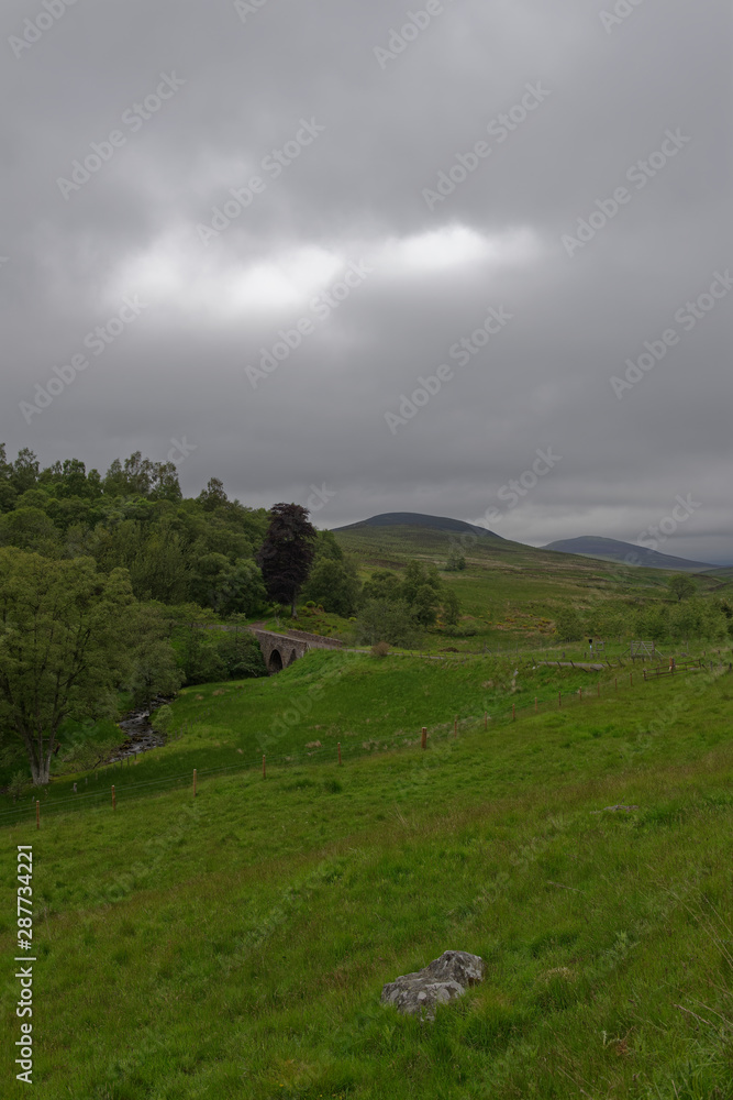 A small Stone bridge on the minor road through Glen Prosen, high up in the Angus Glens of Scotland, on a wet June morning. A small Stone bridge on the minor road through Glen Prosen, high up in the Angus Glens of Scotland, on a wet June morning.