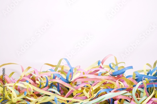 colorful streamers on white background with copy space