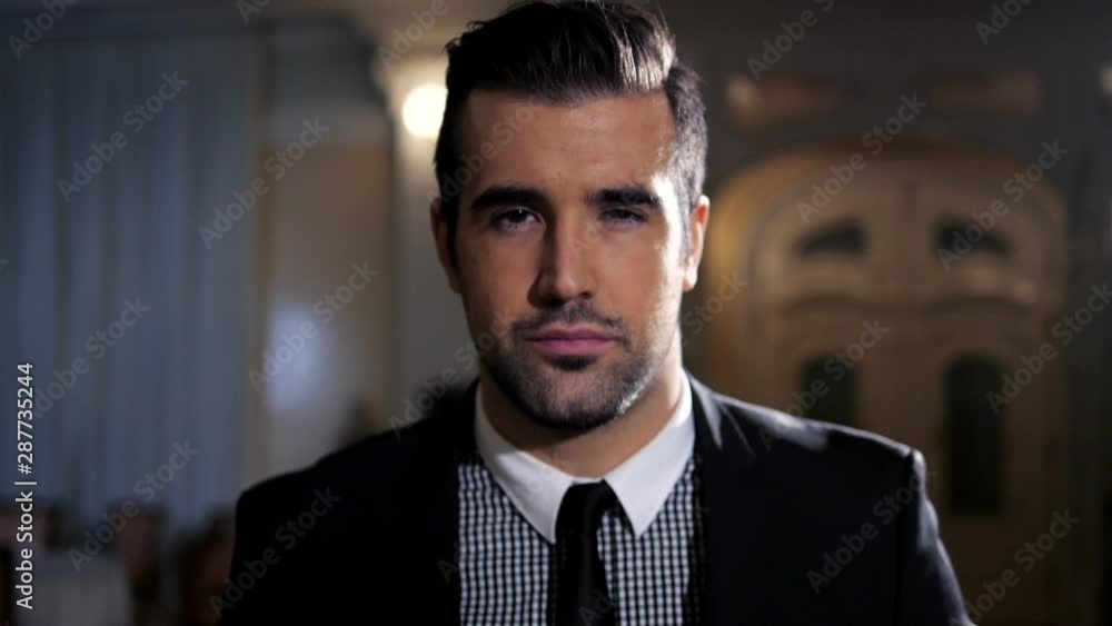Handsome man in suit is walking through lobby Handsome man in suit is walking through lobby
