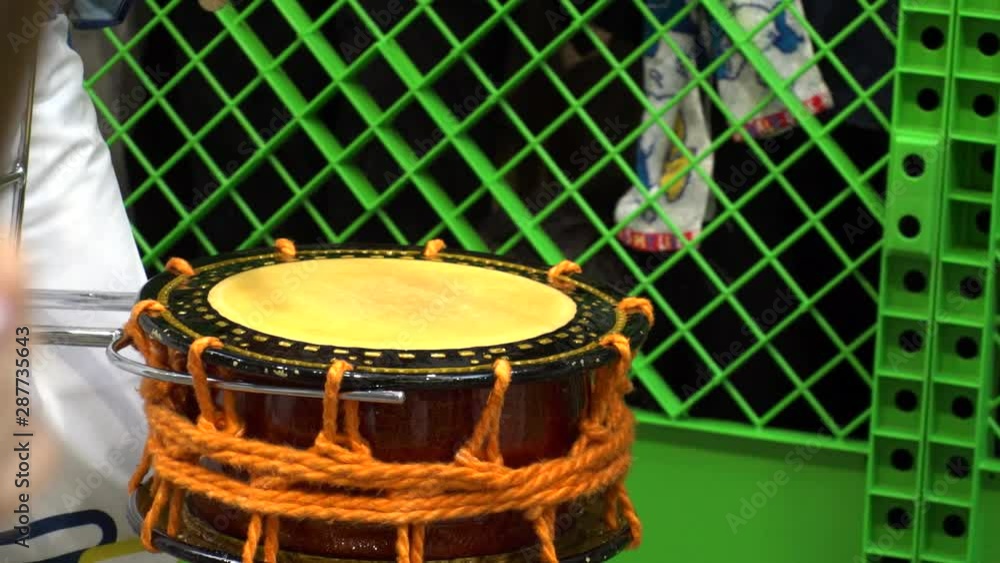 KOENJI, TOKYO, JAPAN - 24 AUGUST 2019 : Close up shot of beating Japanese drum at AWA ODORI FESTIVAL (AWA DANCE FESTIVAL) in Koenji. Slow motion shot. KOENJI, TOKYO, JAPAN - 24 AUGUST 2019 : Close up shot of beating Japanese drum at AWA ODORI FESTIVAL (AWA DANCE FESTIVAL) in Koenji. Slow motion shot.