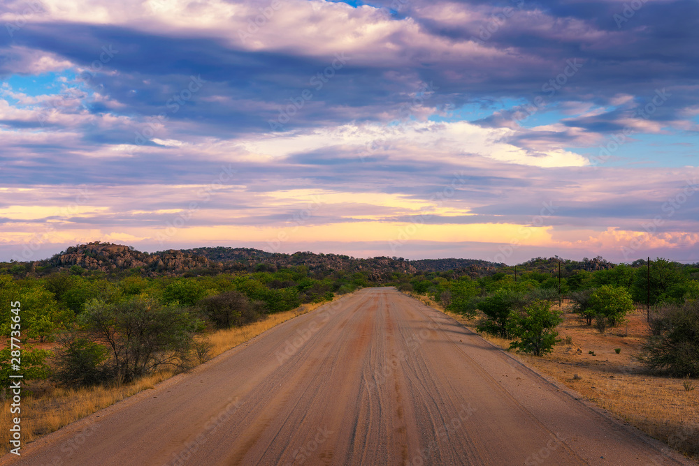 Sunset over the gravel road C35 in Damaraland, Namibia Sunset over the gravel road C35 in Damaraland, Namibia