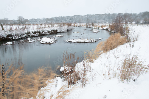 Slow flowing river in winter
