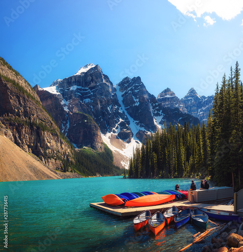Canoes on a jetty at Moraine lake in Canada