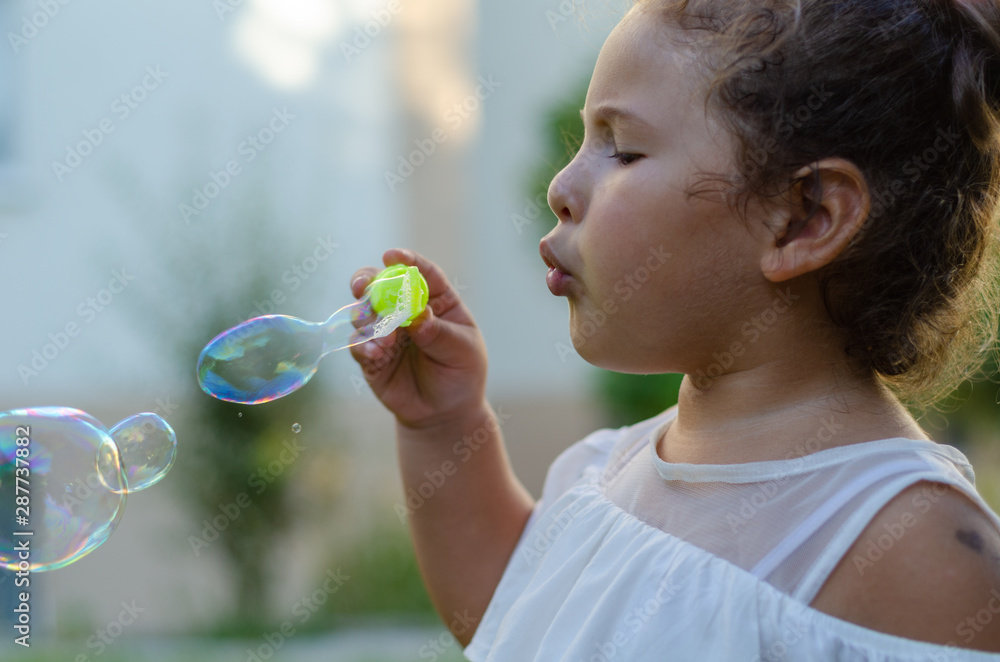 Cute girl blowing soap bubbles Cute girl blowing soap bubbles