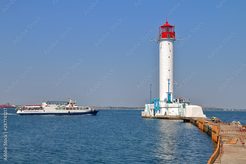Pleasure boat sailing near the Odessa lighthouse.