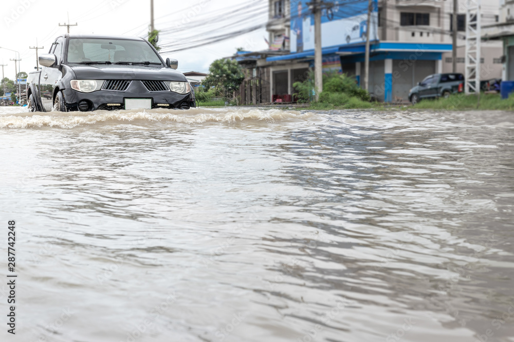 Cars driving on a flooded road, The broken car is parked in a flooded road. . Cars driving on a flooded road, The broken car is parked in a flooded road. .