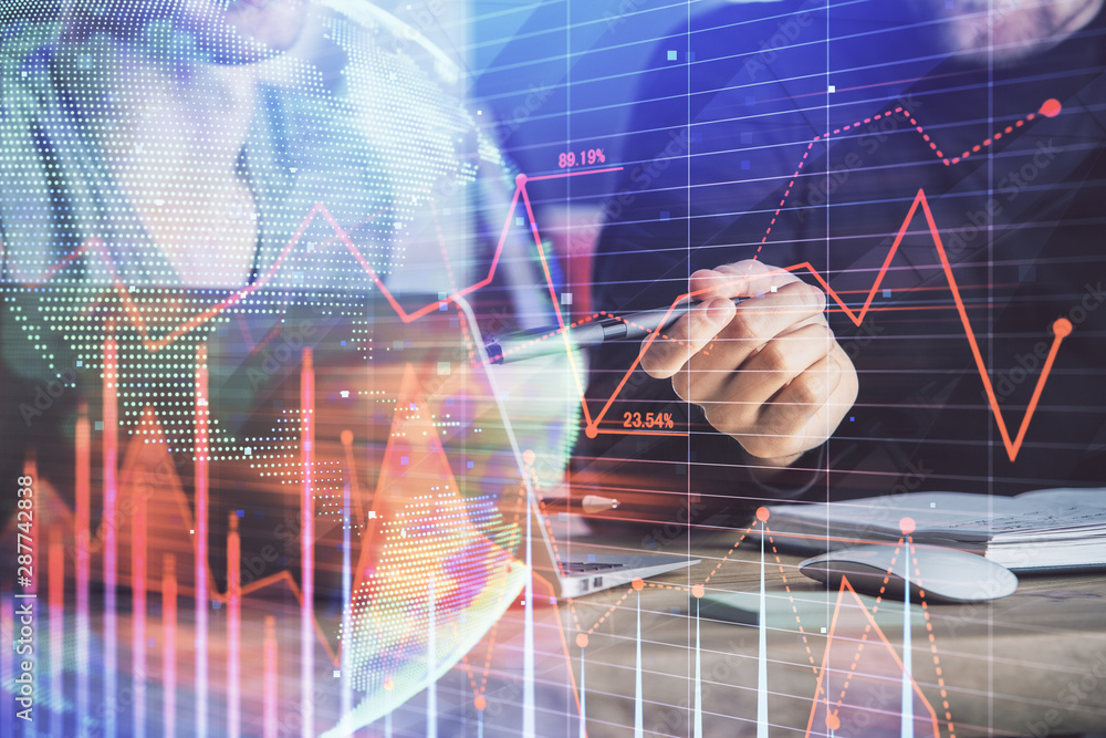 Forex graph with businessman typing on computer in office on background. Concept of analysis. Double exposure. Forex graph with businessman typing on computer in office on background. Concept of analysis. Double exposure.