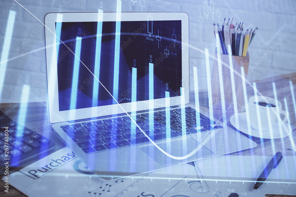 Forex Chart hologram on table with computer background. Double exposure. Concept of financial markets. Forex Chart hologram on table with computer background. Double exposure. Concept of financial markets.