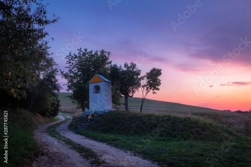 Obraz na płótnie Beautiful purple sunset over christian chapel in Velka Lehota village, Slovakia w salonie