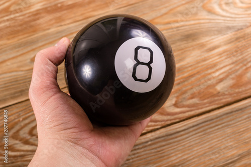 Magic prediction eight ball in hand. photo