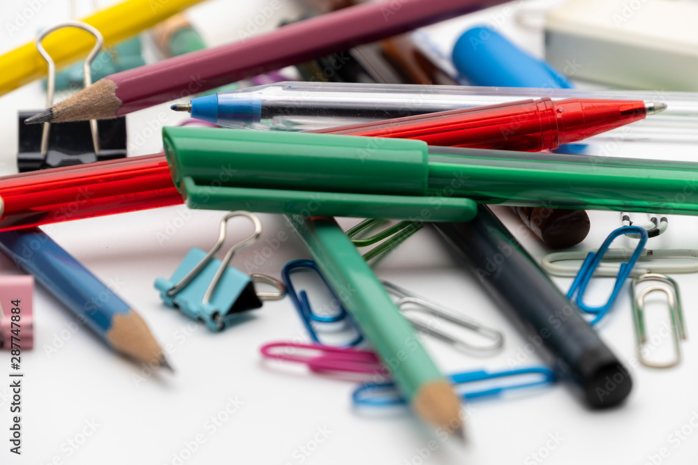 Fototapeta premium Colorful office tools set, pen, binder, paper clip, pencils, eraser isolated on white background
