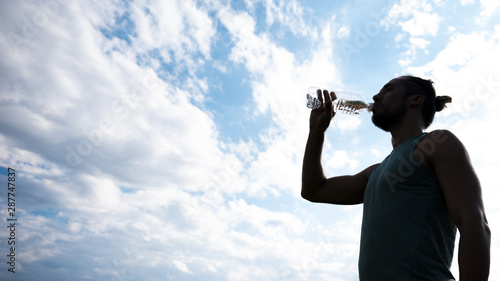 Athlete drinking water with copy space