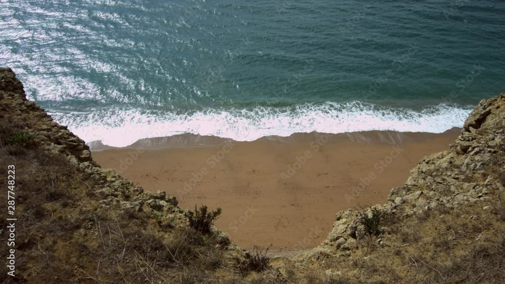 Coastal view. Looking down from large tall towering cliffs onto the sea and beach below. Extreme high angle, vertigo style. Same location as Broadchurch TV series, Westbay, Dorset, UK. Coastal view. Looking down from large tall towering cliffs onto the sea and beach below. Extreme high angle, vertigo style. Same location as Broadchurch TV series, Westbay, Dorset, UK.