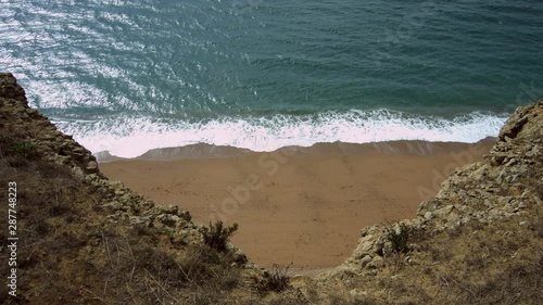 Coastal view. Looking down from large tall towering cliffs onto the sea and beach below. Extreme high angle, vertigo style. Same location as Broadchurch TV series, Westbay, Dorset, UK. photo