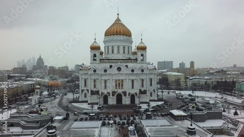 Flying backwards from the Cathedral of Christ the Saviour in winter Moscow, Russia. Second tallest Orthodox Christian church in the world photo