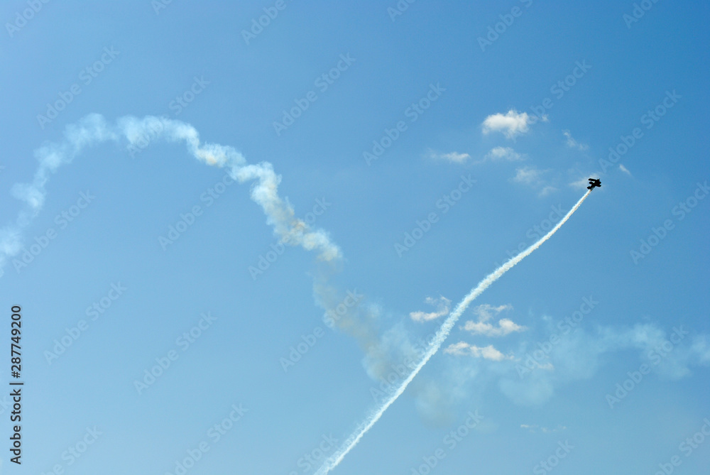 The plane in the blue sky leaving a trail. The plane in the blue sky leaving a trail.