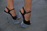 female legs in sandals or shoes with very high heels. High heel and wedge heel. Women's Beauty and Fashion.